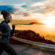 A girl running with great concentration in front of a beautiful sunset